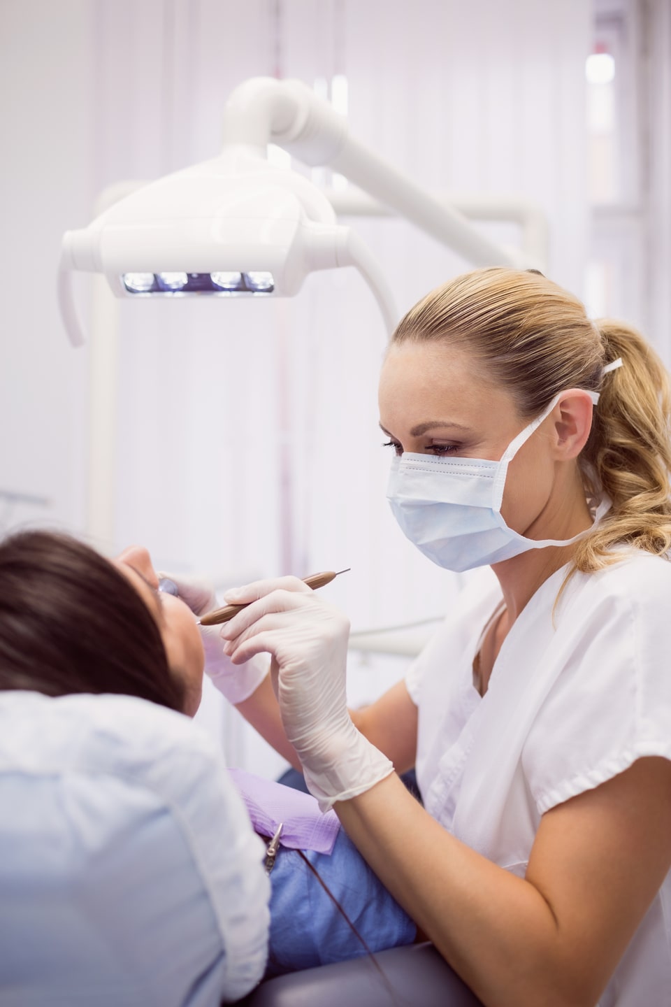 dentist-examining-female-patient (1)-min
